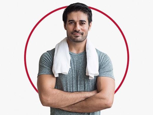 Muscular man with white towel around neck happy after Canesten heat rash treatment